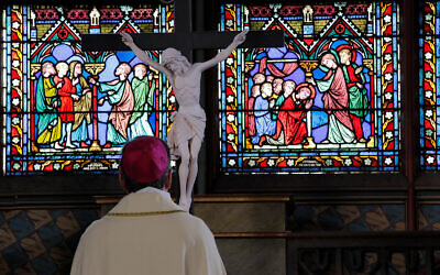 Archbishop of Paris Michel Aupetit prays during the Washing of the Feet ceremony for Maundy Thursday, in Notre Dame Cathedral, April 1, 2021, almost two years after a massive fire ravaged the Gothic cathedral. (AP Photo/Christophe Ena, Pool)