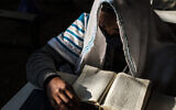 A member of the Ethiopian Jewish community attends a religious service at the synagogue in the city of Gondar, Ethiopia, on October 27, 2020. (Eduardo Soteras/AFP)