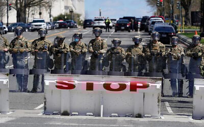 Troops stand guard near the scene of a car that crashed into a barrier on Capitol Hill in Washington, April 2, 2021. (AP Photo/Patrick Semansky)