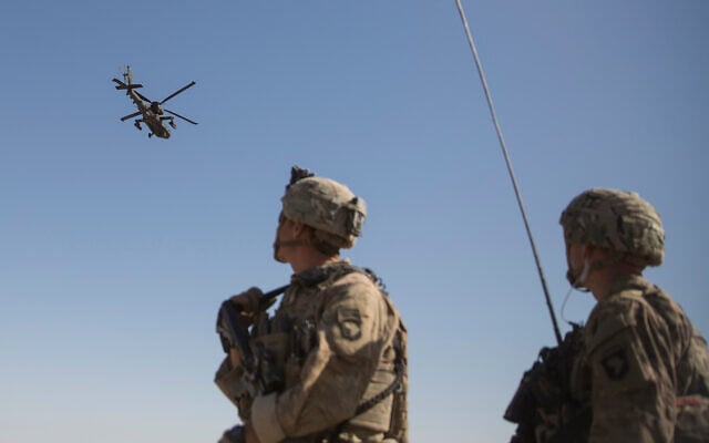 An Apache attack helicopter provides security from above while CH-47 Chinooks drop off supplies to US soldiers at Bost Airfield, Afghanistan, June 10, 2017. (US Marine Corps/Sgt. Justin T. Updegraff, Operation Resolute Support via AP) An Apache attack helicopter provides security from above while CH-47 Chinooks drop off supplies to US soldiers at Bost Airfield, Afghanistan, June 10, 2017. (US Marine Corps/Sgt. Justin T. Updegraff, Operation Resolute Support via AP)