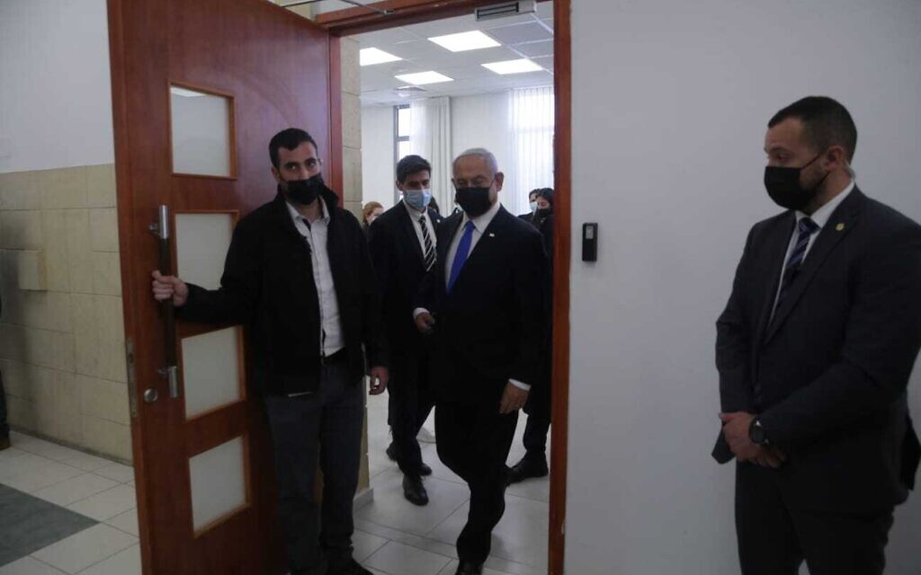 Prime Minister Benjamin Netanyahu, center, leaving a courtroom at the Jerusalem District Court during a hearing in his corruption trial, April 5, 2021. (Oren Ben Hakoon/Pool)