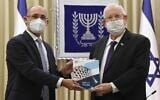 Governor of the Bank of Israel Amir Yaron, left, presents the central bank's annual report to President Reuven Rivlin, April 6, 2021 (Mark Neyman, GPO)