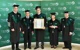 Tal Zaks (C), Moderna's chief medical officer, receives an honorary doctorate during a ceremony at Bar-Ilan University on April 26, 2021. (Courtesy)