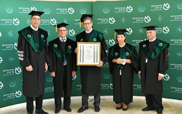 Tal Zaks (C), Moderna's chief medical officer, receives an honorary doctorate during a ceremony at Bar-Ilan University on April 26, 2021. (Courtesy) Tal Zaks (C), Moderna's chief medical officer, receives an honorary doctorate during a ceremony at Bar-Ilan University on April 26, 2021. (Courtesy)