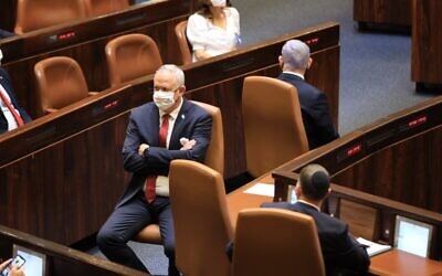 Defense Minister Benny Gantz (left) and Prime Minister Benjamin Netanyahu at the swearing-in ceremony for the 24th Knesset, April 6, 2021. (Knesset spokesperson)
