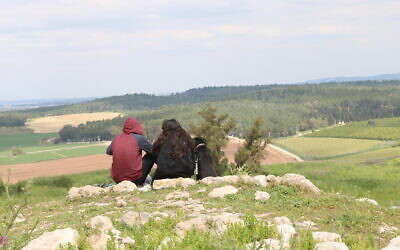 Resting from the climb after reaching the top of Tel Tzafit. (Shmuel Bar-Am)