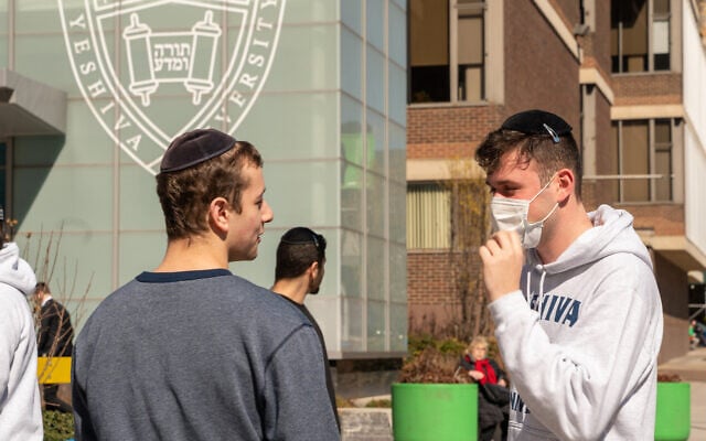 Illustrative: A Yeshiva University student wears a face mask on the grounds of the university in New York City, March 4, 2020. (David Dee Delgado/Getty Images via JTA) Illustrative: A Yeshiva University student wears a face mask on the grounds of the university in New York City, March 4, 2020. (David Dee Delgado/Getty Images via JTA)