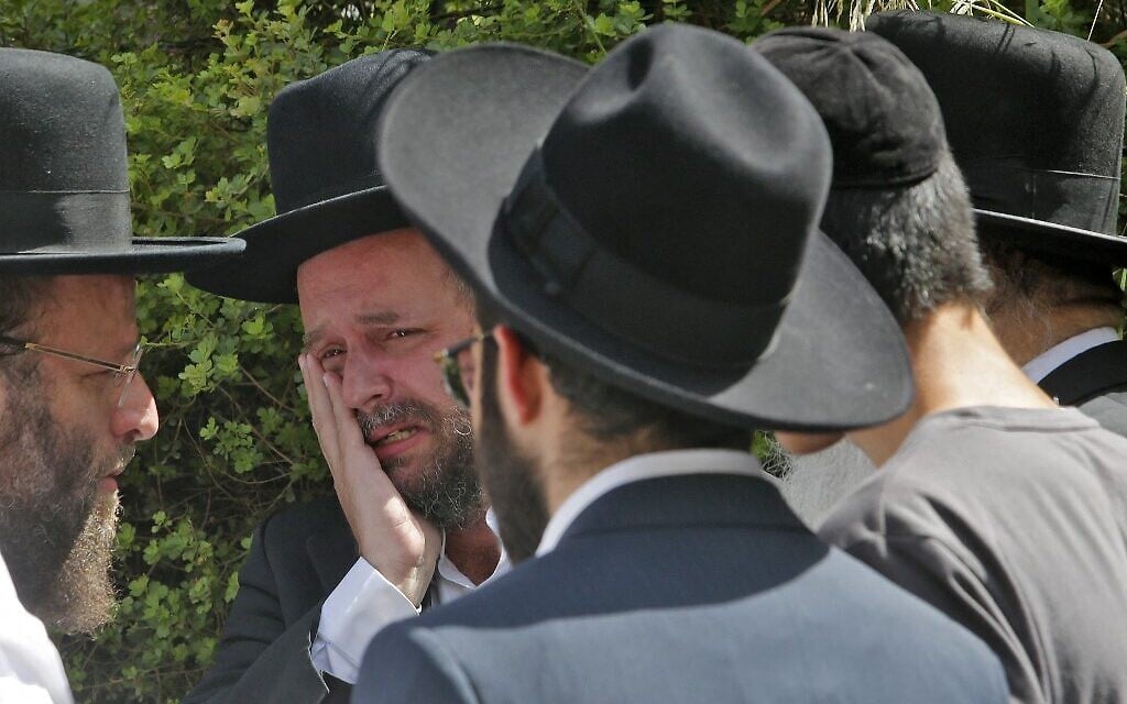 An ultra-Orthodox Jewish man weeps at a cemetery in Bnei Brak, during the funeral of one of the victims of the Meron crush on April 30, 2021. (GIL COHEN-MAGEN / AFP) An ultra-Orthodox Jewish man weeps at a cemetery in Bnei Brak, during the funeral of one of the victims of the Meron crush on April 30, 2021. (GIL COHEN-MAGEN / AFP)