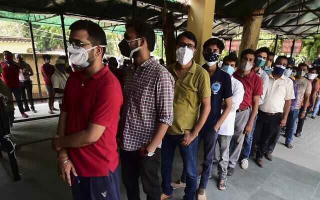 People wait in line to receive a dose of the Covishield coronavirus vaccine, at Tej Bahadur Sapru hospital in Allahabad, on May 1, 2021, during the first day of India's vaccination drive to all adults. (Sanjay Kanoija/AFP) People wait in line to receive a dose of the Covishield coronavirus vaccine, at Tej Bahadur Sapru hospital in Allahabad, on May 1, 2021, during the first day of India's vaccination drive to all adults. (Sanjay Kanoija/AFP)