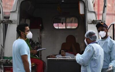 A COVID-19 patient lies in an ambulance while waiting to get an admission in a hospital in New Delhi on May 1, 2021. (Tauseef Mustafa/AFP)