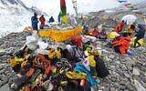 In this photograph taken on May 2, 2021, mountaineers, sherpas and team expedition members prepare for a ritual to pay their respects to Mount Everest before attempting to climb at Everest Base Camp in Solukhumbu district (Prakash MATHEMA / AFP)