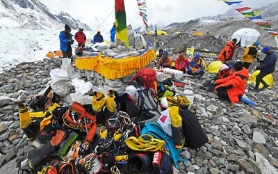 In this photograph taken on May 2, 2021, mountaineers, sherpas and team expedition members prepare for a ritual to pay their respects to Mount Everest before attempting to climb at Everest Base Camp in Solukhumbu district (Prakash MATHEMA / AFP)