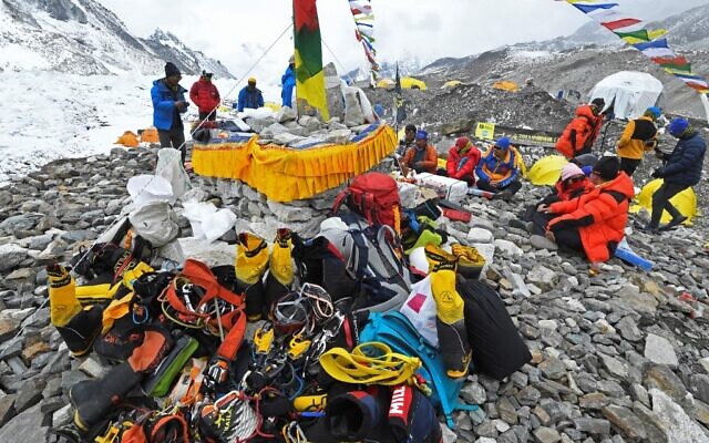 In this photograph taken on May 2, 2021, mountaineers, sherpas and team expedition members prepare for a ritual to pay their respects to Mount Everest before attempting to climb at Everest Base Camp in Solukhumbu district (Prakash MATHEMA / AFP) In this photograph taken on May 2, 2021, mountaineers, sherpas and team expedition members prepare for a ritual to pay their respects to Mount Everest before attempting to climb at Everest Base Camp in Solukhumbu district (Prakash MATHEMA / AFP)