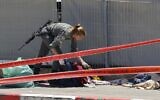 An Israeli soldier checks the belongings of two Palestinian attackers, who opened fire and were killed by Israeli security forces, in front of the IDF military base of Salem near the West Bank town of Jenin, on May 7, 2021. (Photo by Jack GUEZ / AFP)