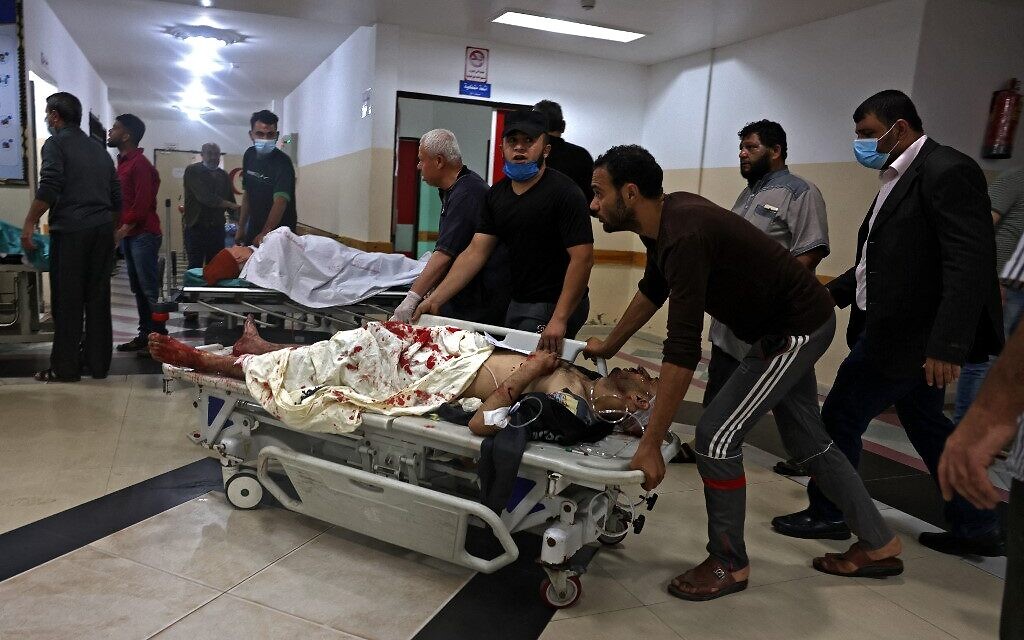 Palestinians transport an injured man amid a flare-up of Israeli-Palestinian violence, at a hospital in the northern Gaza Strip, on May 10, 2021. (MOHAMMED ABED / AFP)