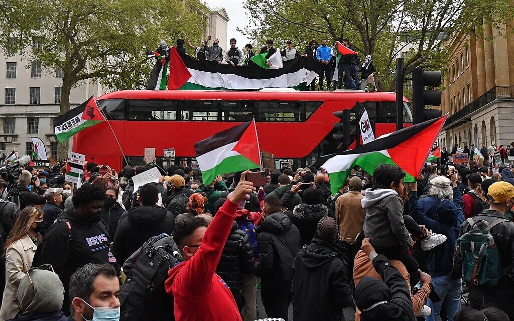 Pro-Palestinian protesters stop a London bus as they participate in a demonstration against Israel, in central London on May 11, 2021. (JUSTIN TALLIS / AFP) Pro-Palestinian protesters stop a London bus as they participate in a demonstration against Israel, in central London on May 11, 2021. (JUSTIN TALLIS / AFP)