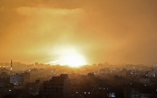 An explosion lights the sky following an Israeli air strike on Beit Lahia in the northern Gaza Strip on May 14, 2021. (Mohammed Abed/AFP) An explosion lights the sky following an Israeli air strike on Beit Lahia in the northern Gaza Strip on May 14, 2021. (Mohammed Abed/AFP)