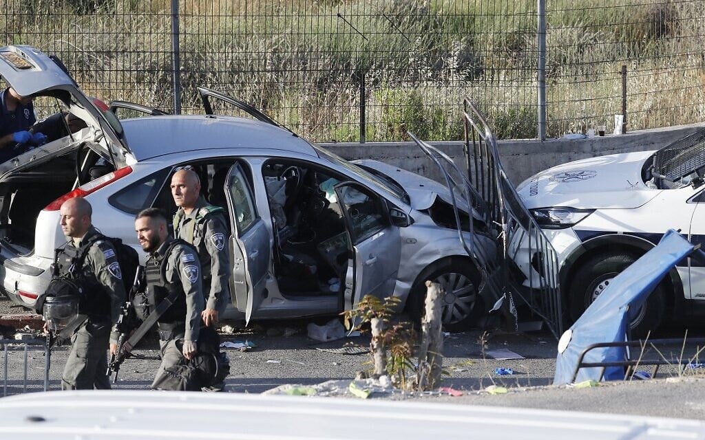Israeli security forces inspect on May 16, 2021 the scene of a car-ramming attack in East Jerusalem. (Ahmad GHARABLI / AFP)