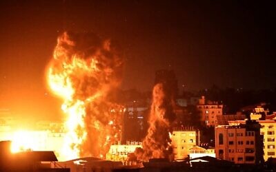 Fire and smoke rise above buildings in Gaza City as Israeli warplanes carry out strikes, early on May 17, 2021.  (Photo by Anas BABA / AFP)