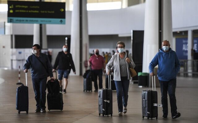 Illustrative: Passengers arrive at Faro airport in Algarve, south of Portugal, on May 17, 2021. (Patricia De Melo Moreira/AFP) Illustrative: Passengers arrive at Faro airport in Algarve, south of Portugal, on May 17, 2021. (Patricia De Melo Moreira/AFP)