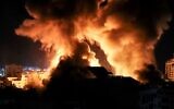 Explosions light-up the night sky above buildings in Gaza City as Israeli forces carry out styrikes on the Palestinian enclave, early on May 18, 2021. (Photo by MAHMUD HAMS / AFP) (Photo by Mahmud hams / AFP)