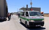 An ambulance passes into Rafah through the Kerem Shalom crossing, the main passage point for goods entering Gaza from Israel, in the southern Gaza Strip on May 18, 2021 (SAID KHATIB / AFP)