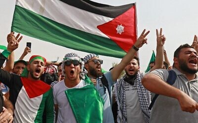 Supporters of Jordan's Muslim Brotherhood take part in a protest in the village of Sweimeh, near the Jordanian border with the West Bank, on May 21, 2021. (Khalil MAZRAAWI / AFP)