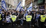 Police maintain a cordon as demonstrators rally in support of Israel outside the Israeli Embassy in central London on May 23, 2021. (Tolga Akmen/AFP)