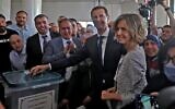 Syrian President Bashar al-Assad and his wife Asma cast their votes at a polling station in Douma, near Damascus on May 26, 2021, as voting began across Syria for an election guaranteed to return Assad for a fourth term in office. (Photo LOUAI BESHARA / AFP)