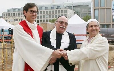 (L to R) Pastor Gregor Hohberg, Rabbi Andreas Nachama and Imam Kadir Sanci pose during the groundbreaking ceremony of the multi-religion building 'House Of One' on May 27, 2021 (Photo by Wolfgang Kumm / dpa / AFP)
