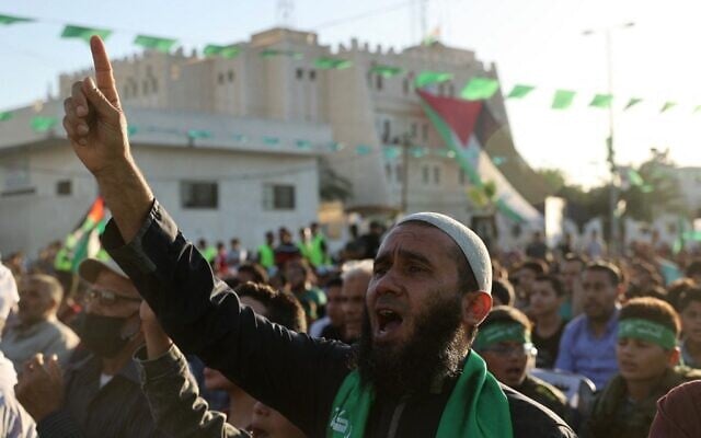 Palestinian supporters of the Hamas terror group's military wing attend a parade in Khan Yunis, in the southern Gaza Strip on May 27, 2021, as Hamas claims victory following an 11-day conflict with Israel.(SAID KHATIB / AFP)