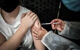 A patient receives a dose of the Pfizer-BioNTech vaccine against COVID-19 at a temporary vaccination center in Versailles, France on May 29, 2021. (STEPHANE DE SAKUTIN / AFP)