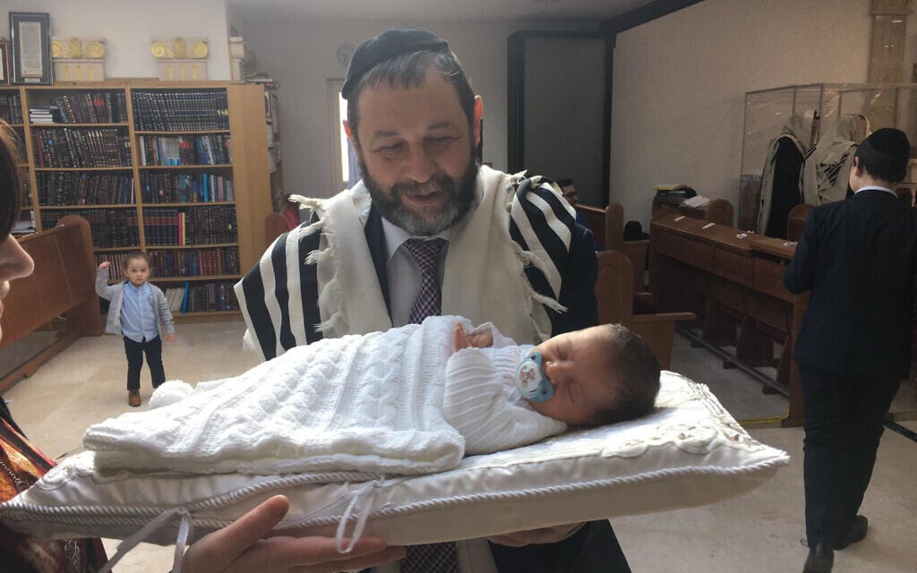 Eli Seliger looks at a baby in London, April 2021. (Courtesy of Eli Seliger/ via JTA) Eli Seliger looks at a baby in London, April 2021. (Courtesy of Eli Seliger/ via JTA)