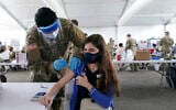 Natalie Ruiz,19, receives the Pfizer COVID-19 vaccine at a FEMA vaccination center at Miami Dade College, Monday, April 5, 2021, in Miami.  (AP Photo/Lynne Sladky)