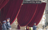 Police officers stand in front of the 'Grand Hotel Wien' in Vienna, Austria, Friday, April 9, 2021, where closed-door nuclear talks with Iran take place. (AP Photo/Florian Schroetter)