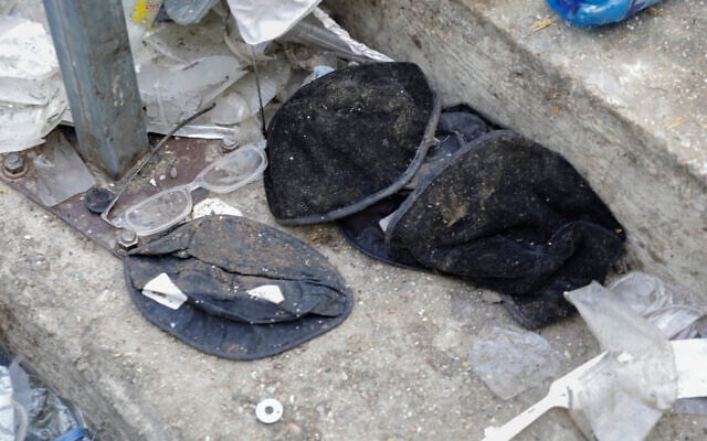 Hats and broken glasses are seen at the bottom of a stairway leading from a narrow walkway where a fatal crush occurred at the site of the Mt. Meron disaster in northern Israel, Friday, April 30, 2021 (AP Photo/Sebastian Scheiner) Hats and broken glasses are seen at the bottom of a stairway leading from a narrow walkway where a fatal crush occurred at the site of the Mt. Meron disaster in northern Israel, Friday, April 30, 2021 (AP Photo/Sebastian Scheiner)