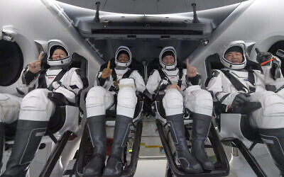 NASA astronauts Shannon Walker, left, Victor Glover, Mike Hopkins, and Japan Aerospace Exploration Agency (JAXA) astronaut Soichi Noguchi, right are seen inside the SpaceX Crew Dragon Resilience spacecraft onboard the SpaceX GO Navigator recovery ship shortly after having landed in the Gulf of Mexico off the coast of Panama City, Florida, Sunday, May 2, 2021. (Bill Ingalls/NASA via AP)