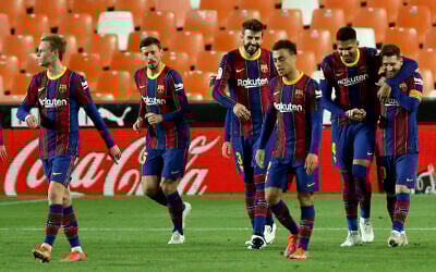 Barcelona's Lionel Messi (R) celebrates with teammates after scoring his side's 3rd goal during the Spanish La Liga soccer match between Valencia and Barcelona at the Mestalla stadium in Valencia, Spain, May 2, 2021. (AP Photo/Alberto Saiz)