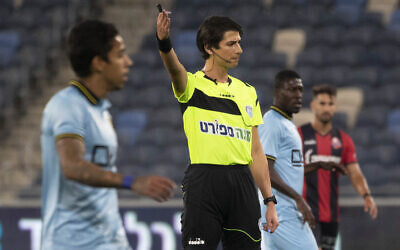 Referee Sapir Berman works during an Israeli Premier League soccer match between Hapoel Haifa and Beitar Jerusalem in the northern Israeli city of Haifa, Monday, May 3, 2021. Israeli soccer's first transgender soccer referee took the field Monday for the first time since coming out publicly as a woman last week. (AP Photo/Sebastian Scheiner)