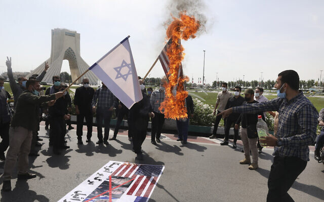 Demonstrators burn representations of Israeli and US flags during the annual Al-Quds Day rally in Tehran, Iran, May 7, 2021  (AP Photo/Vahid Salemi)
