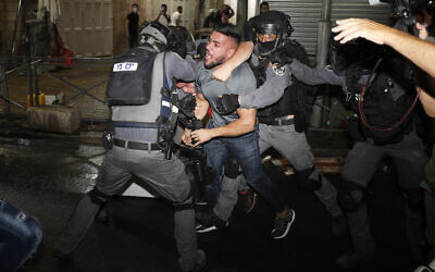 Israeli police officers clash with Palestinian protesters near Damascus Gate just outside Jerusalem's Old City on May 9, 2021. (AP/Ariel Schalit) Israeli police officers clash with Palestinian protesters near Damascus Gate just outside Jerusalem's Old City on May 9, 2021. (AP/Ariel Schalit)