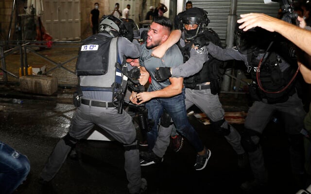 Israeli police officers clash with Palestinian protesters near Damascus Gate just outside Jerusalem's Old City on May 9, 2021. (AP/Ariel Schalit) Israeli police officers clash with Palestinian protesters near Damascus Gate just outside Jerusalem's Old City on May 9, 2021. (AP/Ariel Schalit)