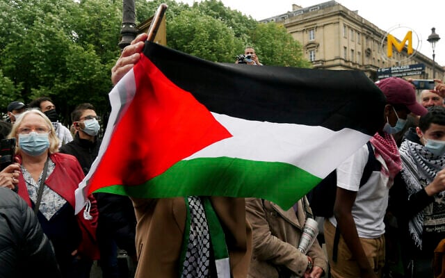 Illustrative: A protester waves a flag during a protest in solidarity with Palestinians, in Paris, Wednesday, May 12, 2021. (AP/Thibault Camus) Illustrative: A protester waves a flag during a protest in solidarity with Palestinians, in Paris, Wednesday, May 12, 2021. (AP/Thibault Camus)