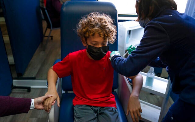 A boy holds his mother's hand as he receives the Pfizer COVID-19 vaccine. (AP Photo/Jae C. Hong) A boy holds his mother's hand as he receives the Pfizer COVID-19 vaccine. (AP Photo/Jae C. Hong)