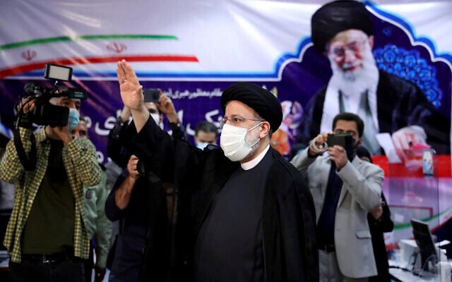 Ebrahim Raisi, head of Iran's judiciary, waves to media as he attends at the Interior Ministry to register his candidacy for the June 18 presidential elections at the elections headquarters of the Interior Ministry in Tehran, Iran, May 15, 2021. (Ebrahim Noroozi/AP) Ebrahim Raisi, head of Iran's judiciary, waves to media as he attends at the Interior Ministry to register his candidacy for the June 18 presidential elections at the elections headquarters of the Interior Ministry in Tehran, Iran, May 15, 2021. (Ebrahim Noroozi/AP)