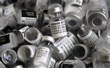 Empty vials of the Pfizer-BioNTech COVID-19 vaccine lie in a box during a vaccine campaign at the Vaccine Village in Ebersberg near Munich, Germany, May 15, 2021. (AP Photo/Matthias Schrader)