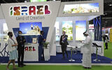 Israeli exhibitors receive visitors at their stand on the opening day of the Arabian Travel Market exhibition, in Dubai, United Arab Emirates, Sunday, May 16, 2021. (AP Photo/Kamran Jebreili)