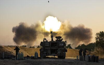In this May 19, 2021, photo, an Israeli artillery unit fires shells toward targets in Gaza. (AP Photo/Tsafrir Abayov)