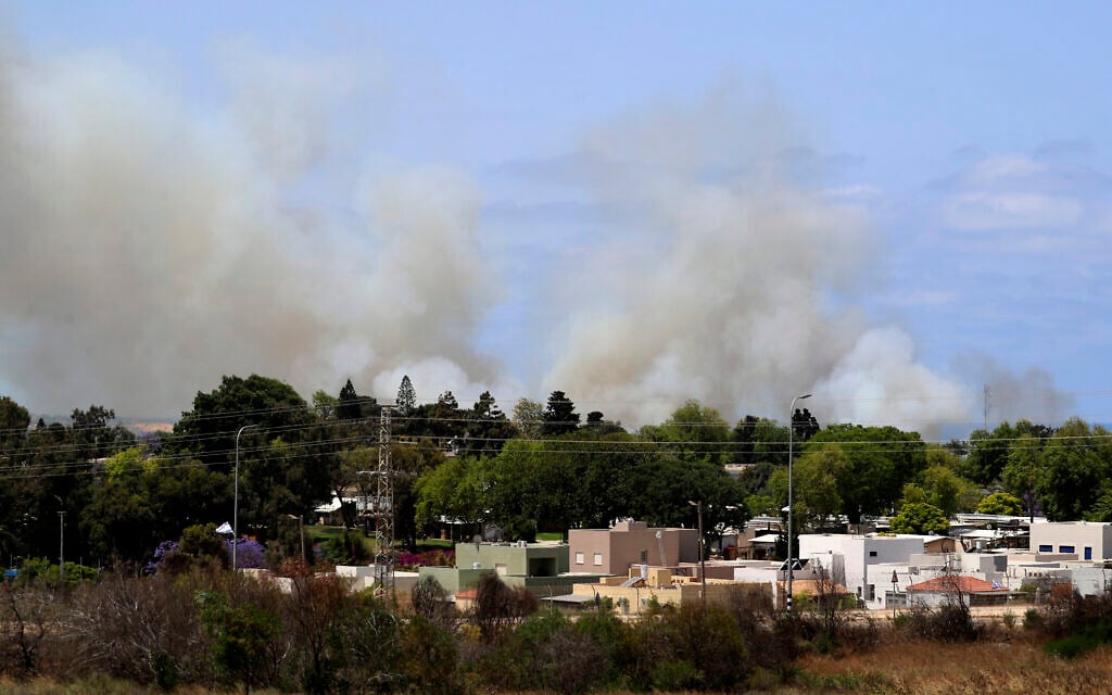 Smoke rises in a community in southern Israel after it was struck by a rocket fired from the Gaza Strip, May 20, 2021. (AP Photo/Ariel Schalit)