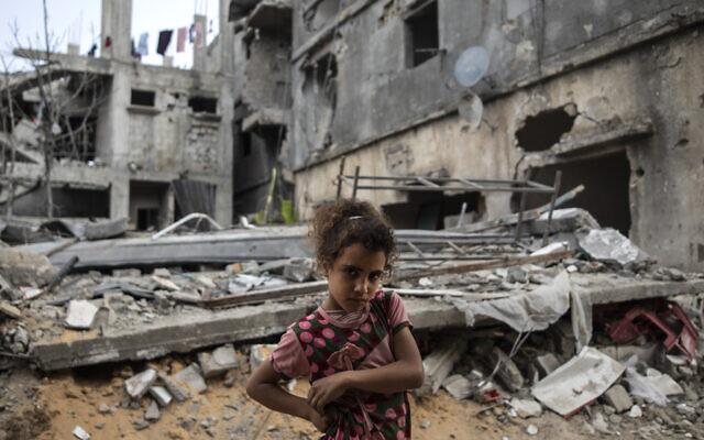 Palestinian Rahaf Nuseir, 10, looks on as she stands in front of her family's destroyed homes, to which they returned following a cease-fire reached after an 11-day war between Gaza's Hamas rulers and Israel, in town of Beit Hanoun, northern Gaza Strip, Friday, May 21, 2021. (AP/Khalil Hamra) Palestinian Rahaf Nuseir, 10, looks on as she stands in front of her family's destroyed homes, to which they returned following a cease-fire reached after an 11-day war between Gaza's Hamas rulers and Israel, in town of Beit Hanoun, northern Gaza Strip, Friday, May 21, 2021. (AP/Khalil Hamra)